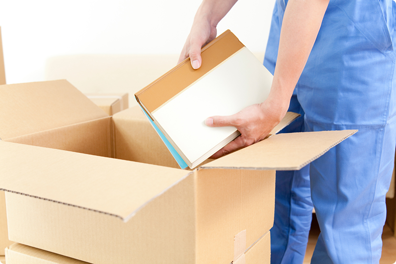 ダンボール箱のなかに荷物を入れるイメージ画像